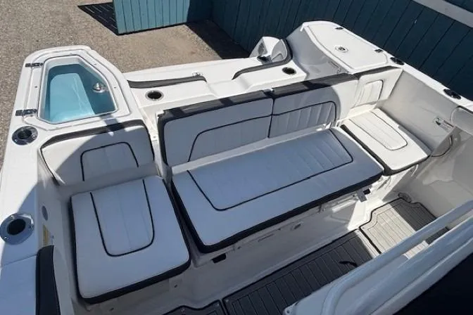 Slide: The Image of 2026 Yamaha Boats 255 FSH Sport H interior with white cushioned seating. - 31