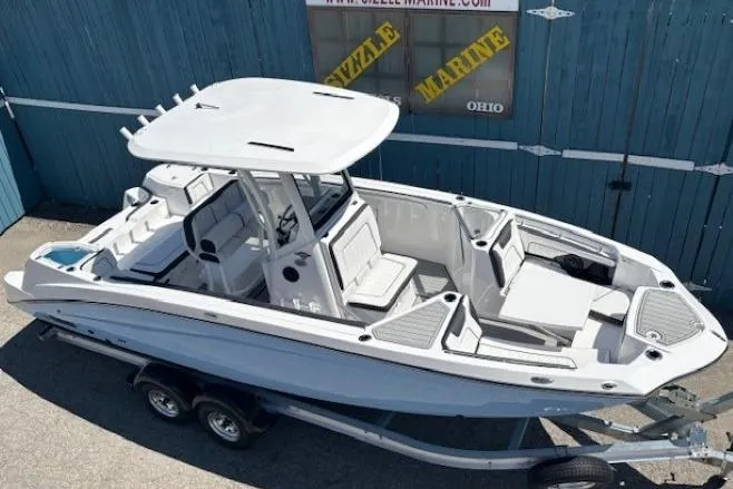 Slide: The Image of 2026 Yamaha Boats 255 FSH Sport H on trailer, sleek design, blue background. - 5