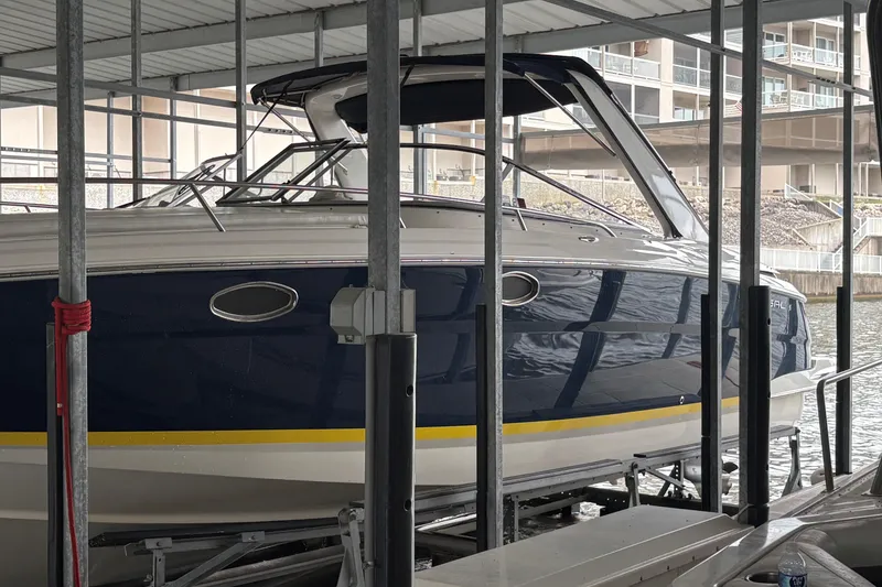 The Image of 2005 Regal 3350 Sport Cruiser docked in a covered marina. - 0