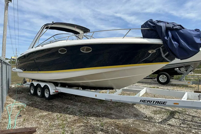 Slide: The Image of 2005 Regal 3350 Sport Cruiser on trailer, parked outdoors under blue sky. - 10