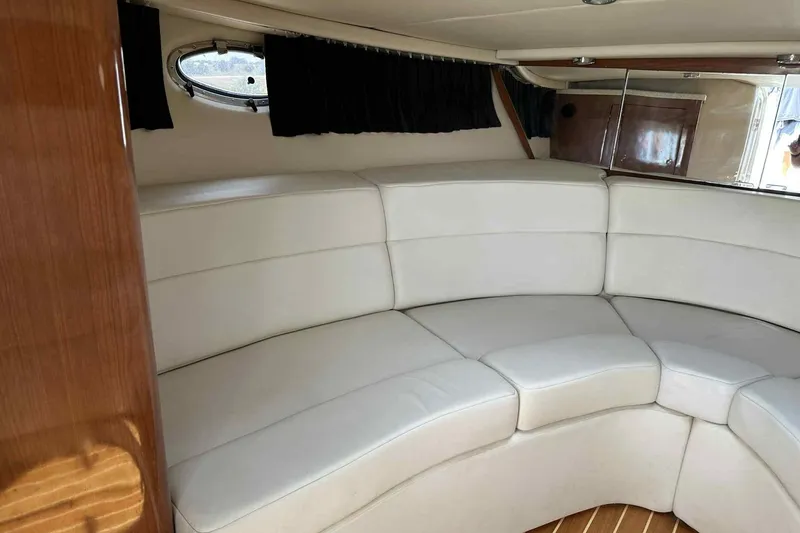 Slide: The Image of 2005 Regal 3350 Sport Cruiser interior with white leather seating and wood accents. - 12