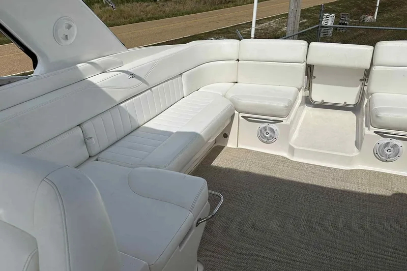 Slide: The Image of 2005 Regal 3350 Sport Cruiser interior with white seating and carpeted floor. - 13