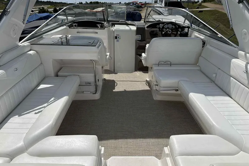 Slide: The Image of 2005 Regal 3350 Sport Cruiser interior with white seating and helm, showcasing luxury design. - 14