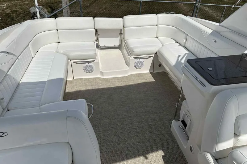 Slide: The Image of 2005 Regal 3350 Sport Cruiser interior with white seating and carpeted floor. - 16