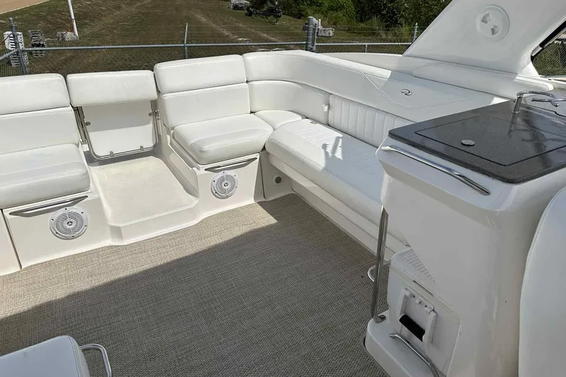 Slide: The Image of 2005 Regal 3350 Sport Cruiser interior with white seating and built-in speakers. - 17