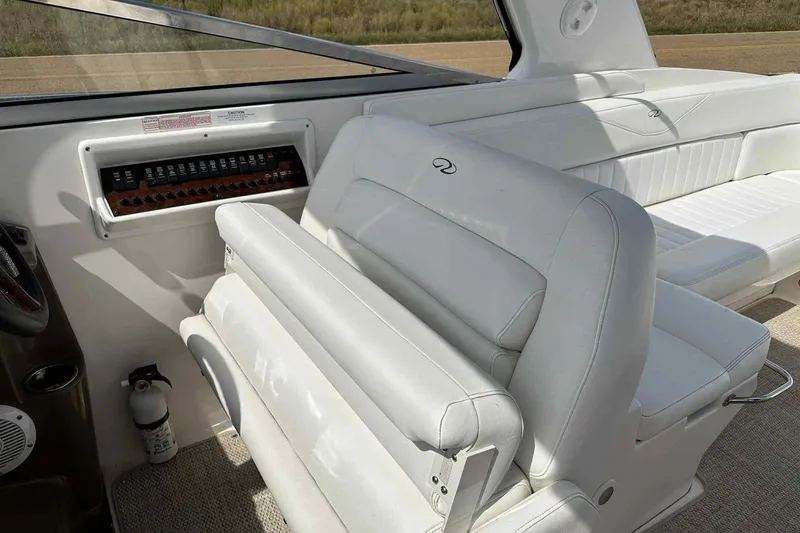 Slide: The Image of 2005 Regal 3350 Sport Cruiser interior with white seating and control panel. - 29