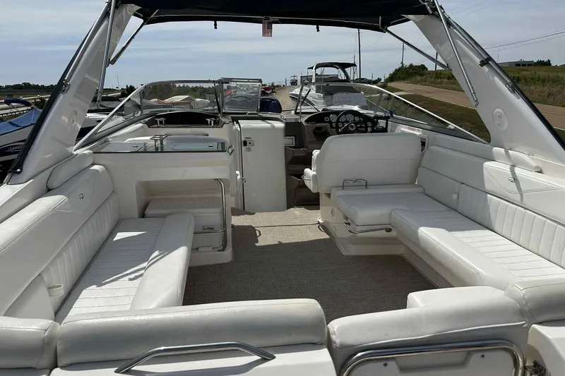 Slide: The Image of 2005 Regal 3350 Sport Cruiser interior with white seating and modern dashboard. - 33