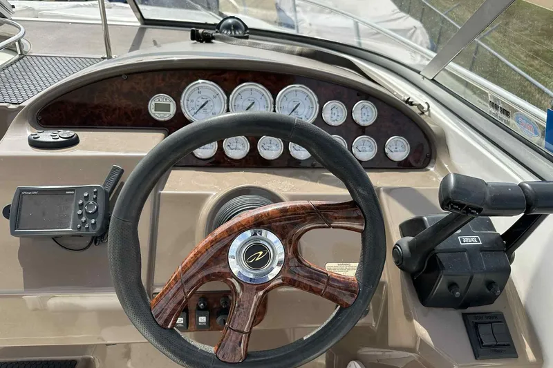 Slide: The Image of Dashboard of a 2005 Regal 3350 Sport Cruiser with steering wheel and gauges. - 34