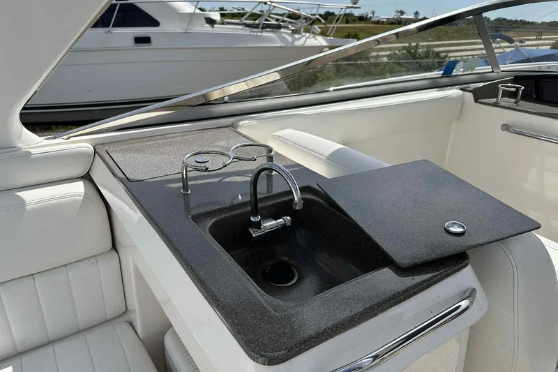 Slide: The Image of 2005 Regal 3350 Sport Cruiser interior with sink and countertop in cockpit area. - 36