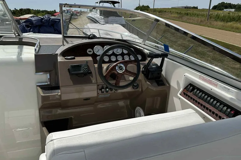Slide: The Image of 2005 Regal 3350 Sport Cruiser dashboard with steering wheel and control panel. - 37