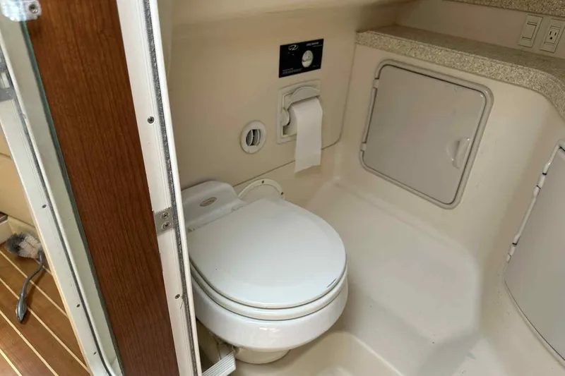 Slide: The Image of 2005 Regal 3350 Sport Cruiser bathroom with toilet and storage compartment. - 38