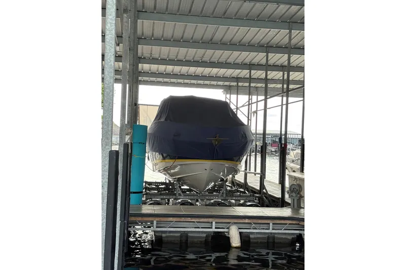 Slide: The Image of 2005 Regal 3350 Sport Cruiser docked under a covered marina. - 6