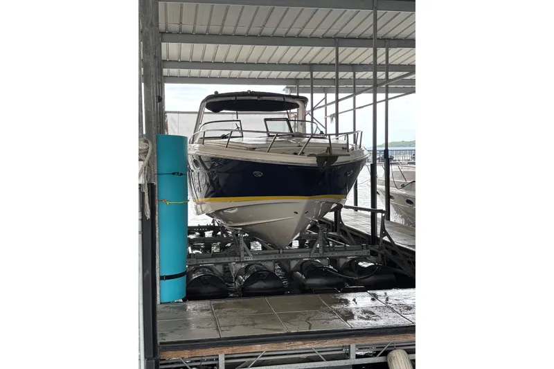 Slide: The Image of 2005 Regal 3350 Sport Cruiser docked in a covered marina. - 7