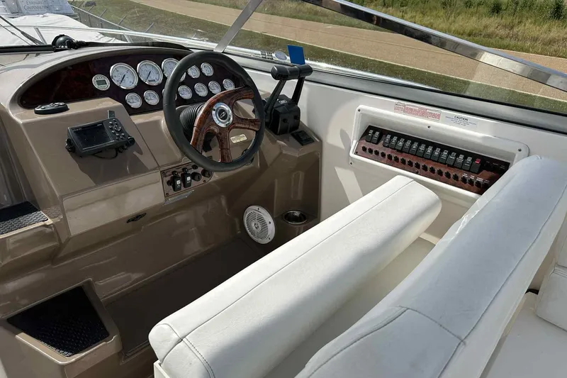 Slide: The Image of 2005 Regal 3350 Sport Cruiser dashboard with steering wheel and control panel. - 9