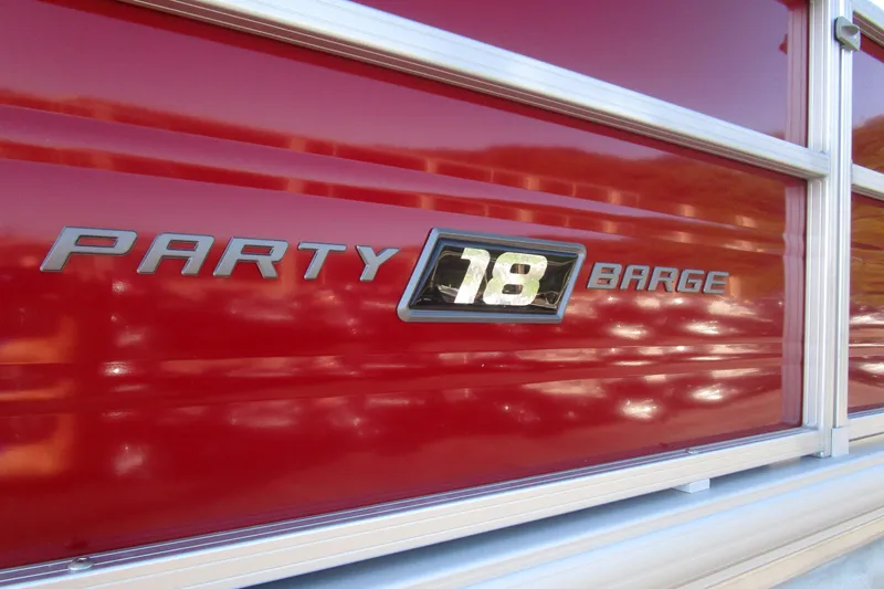 Slide: The Image of 2026 Sun Tracker Party Barge 18, red exterior with model nameplate. - 11