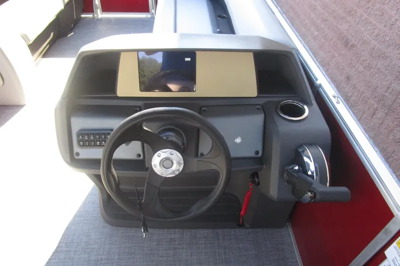 Slide: The Image of 2026 Sun Tracker Party Barge 18 dashboard with steering wheel and controls. - 4