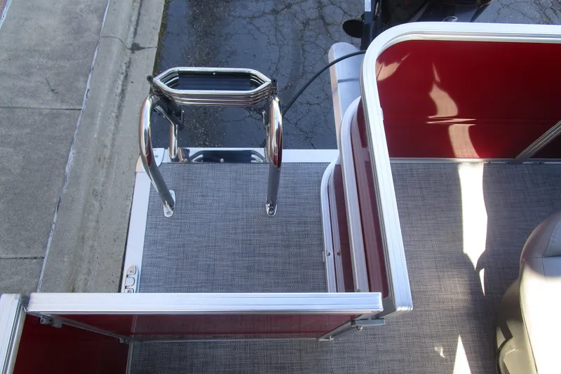Slide: The Image of 2026 Sun Tracker Party Barge 18 pontoon boat with red interior and boarding ladder. - 7