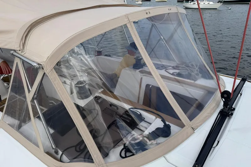 Slide: The Image of Jeanneau 409 sailboat cockpit with protective canopy, docked in a marina. - 11
