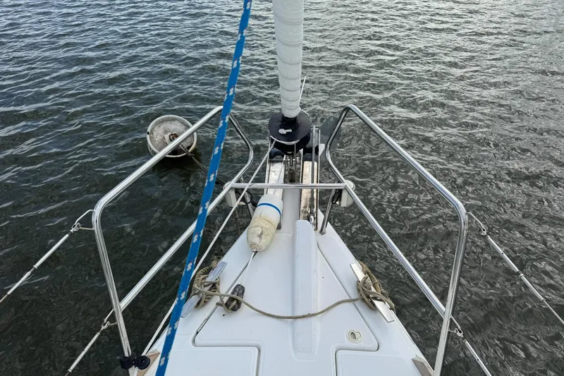 Slide: The Image of Bow view of Jeanneau 409 sailboat with mooring buoy in water. - 17