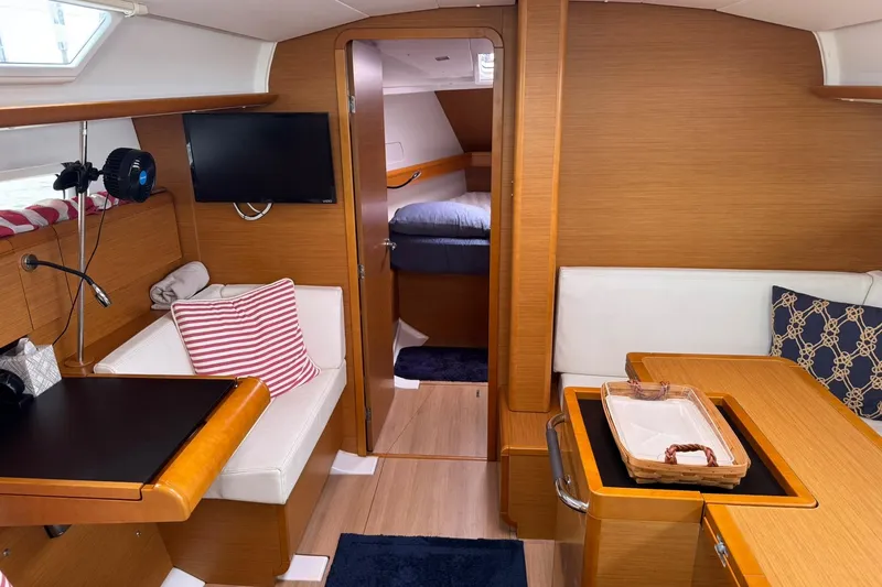 Slide: The Image of Interior of 2013 Jeanneau 409 sailboat with cozy seating and modern amenities. - 18