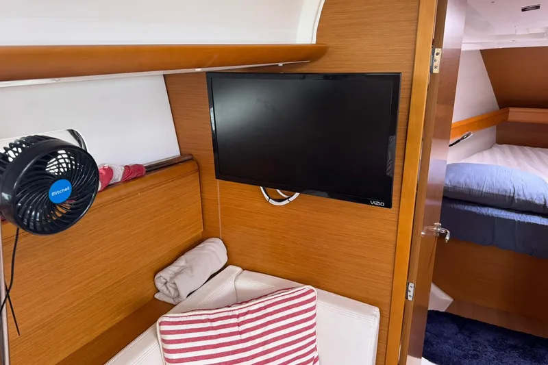 Slide: The Image of Interior of 2013 Jeanneau 409 yacht with TV, fan, and cozy seating area. - 21