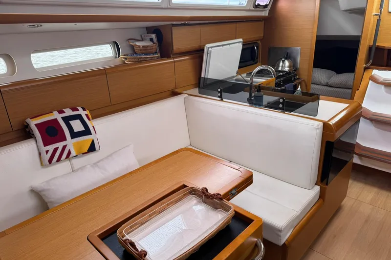 Slide: The Image of Interior of 2013 Jeanneau 409 sailboat with cozy seating and modern kitchen area. - 23