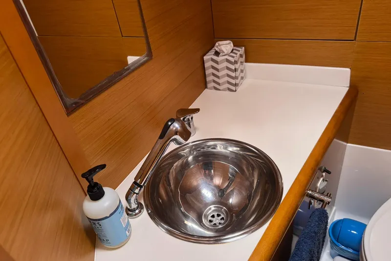 Slide: The Image of Bathroom sink area in a 2013 Jeanneau 409 yacht, featuring a stainless steel basin. - 30