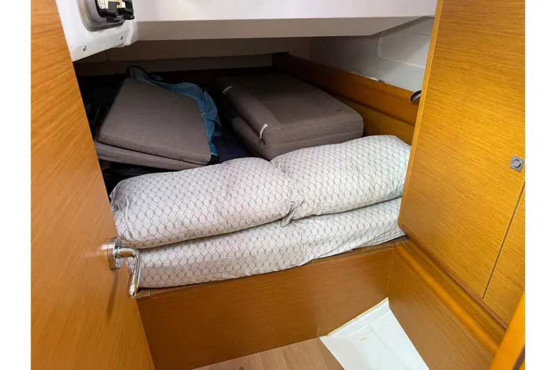 Slide: The Image of Cozy cabin interior of 2013 Jeanneau 409 sailboat with cushions and bedding. - 34