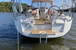 Slide: The Image of 2013 Jeanneau Sun Odyssey 409 sailboat on calm water, rear view. - 39