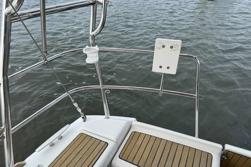 Slide: The Image of Jeanneau 409 boat deck with stainless steel railing and wooden flooring. - 4