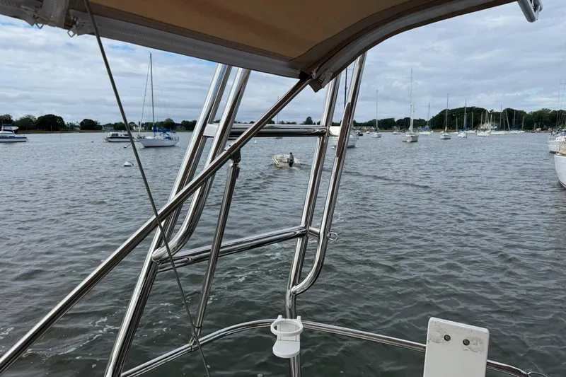 Slide: The Image of View from Jeanneau 409 sailboat, overlooking a marina with moored boats and calm waters. - 5