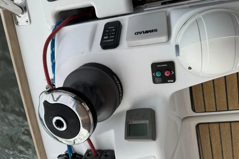 Slide: The Image of Jeanneau 409 sailboat deck with winch, control panel, and teak flooring. - 7