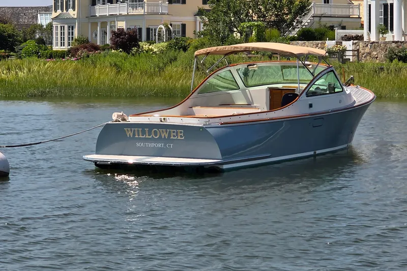 Slide: The Image of 2006 Nordic Star 33 Runabout boat docked in scenic waters near elegant homes. - 11