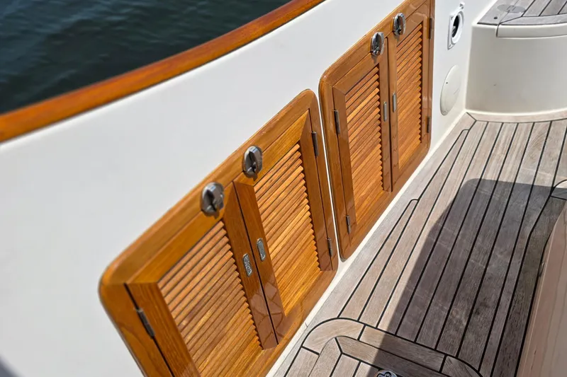 Slide: The Image of Wooden deck and storage doors on a 2006 Nordic Star 33 Runabout boat. - 13
