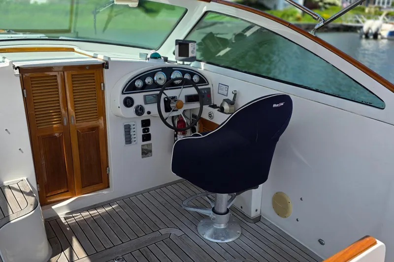 Slide: The Image of Nordic Star 33 Runabout 2006 cockpit with steering wheel and wooden cabinetry. - 16
