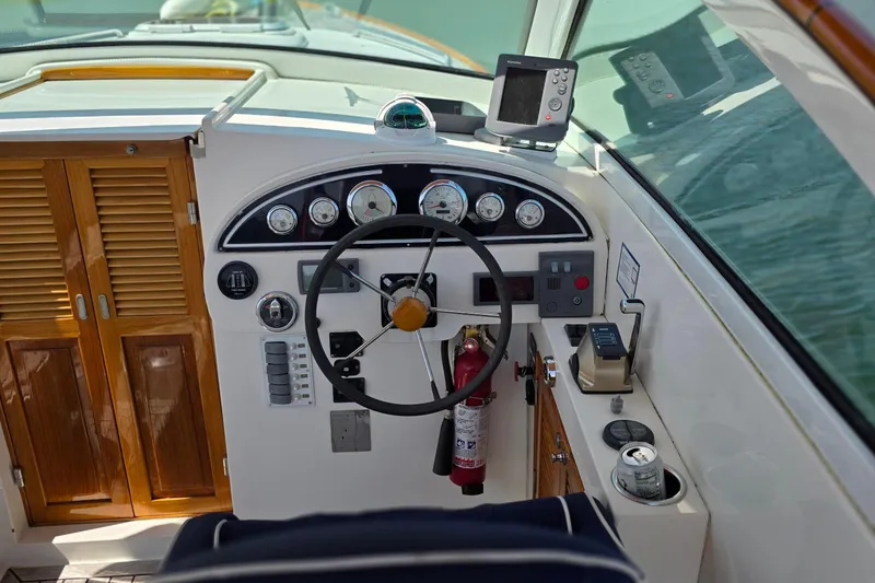 Slide: The Image of 2006 Nordic Star 33 Runabout cockpit with steering wheel, gauges, and navigation equipment. - 17