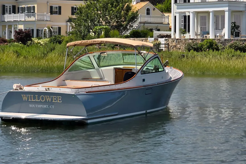 Slide: The Image of 2006 Nordic Star 33 Runabout boat on water near elegant waterfront homes. - 3