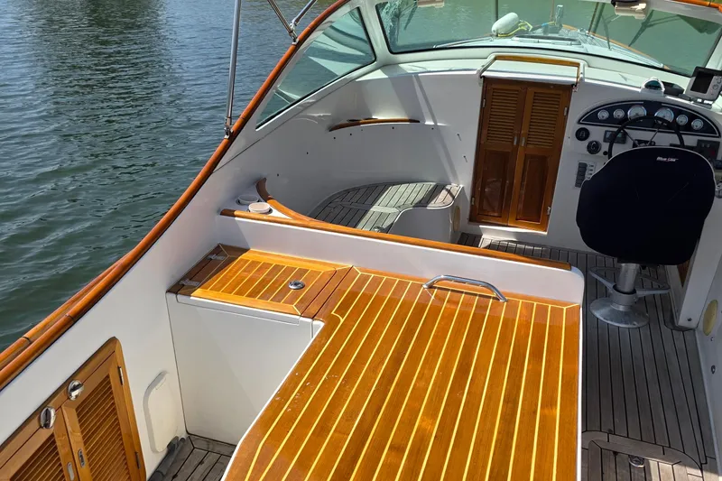 Slide: The Image of 2006 Nordic Star 33 Runabout boat interior with wooden deck and steering area. - 4