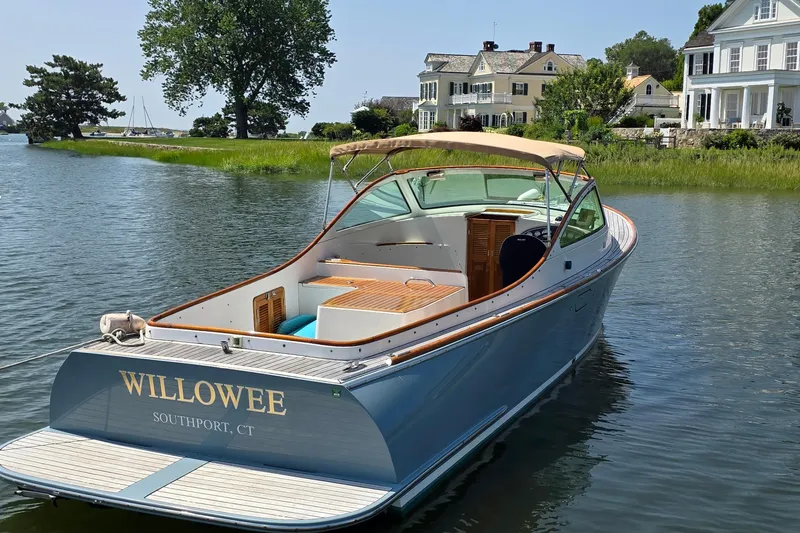 Slide: The Image of 2006 Nordic Star 33 Runabout boat docked near elegant waterfront homes. - 9