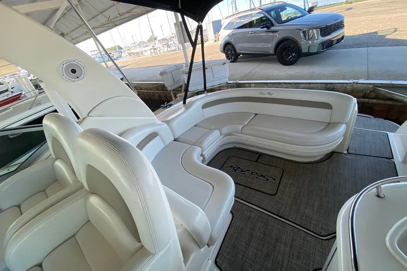 Slide: The Image of 2004 Sea Ray 340 Sundancer boat interior with white seating and carpeted floor. - 11