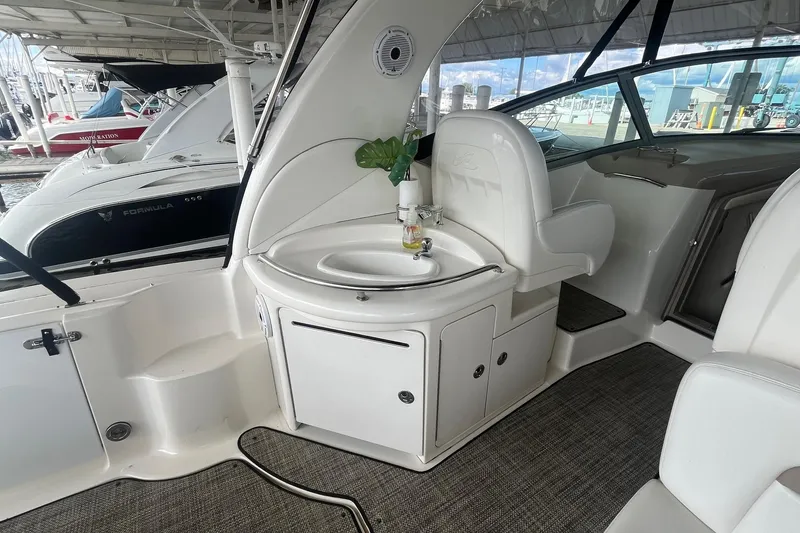 Slide: The Image of 2004 Sea Ray 340 Sundancer interior with sink and seating area. - 13