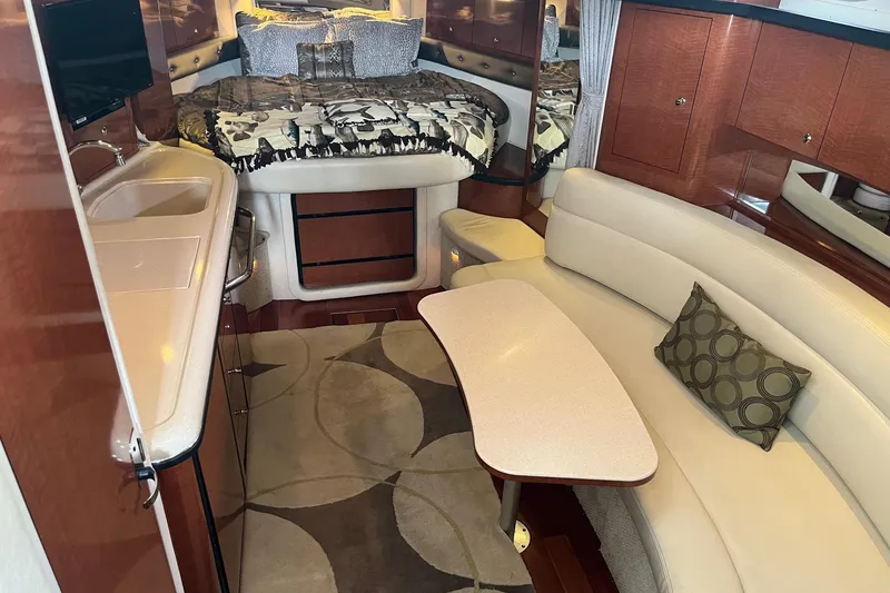 Slide: The Image of Interior of 2004 Sea Ray 340 Sundancer yacht with cozy seating and modern amenities. - 19