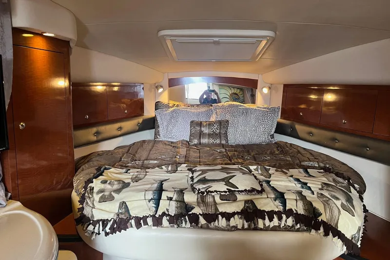 Slide: The Image of Luxurious cabin interior of 2004 Sea Ray 340 Sundancer with cozy bedding and wood accents. - 20