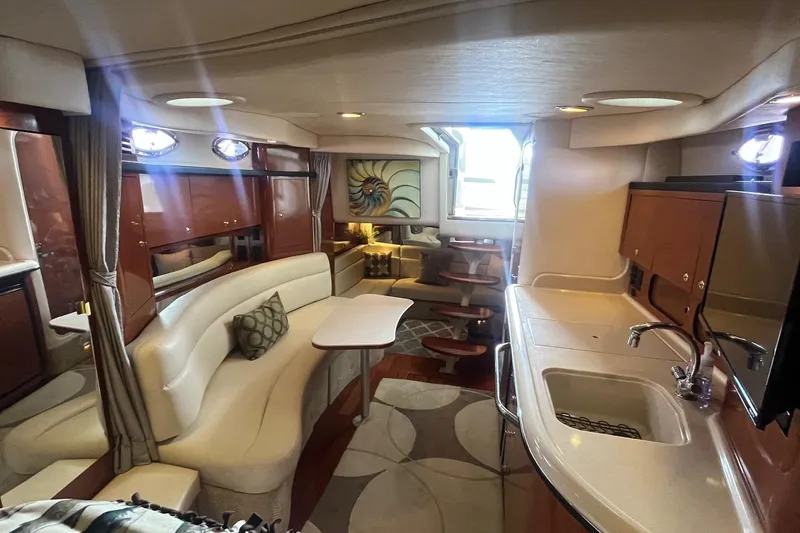 Slide: The Image of Luxurious interior of a 2004 Sea Ray 340 Sundancer yacht with elegant seating and kitchenette. - 21
