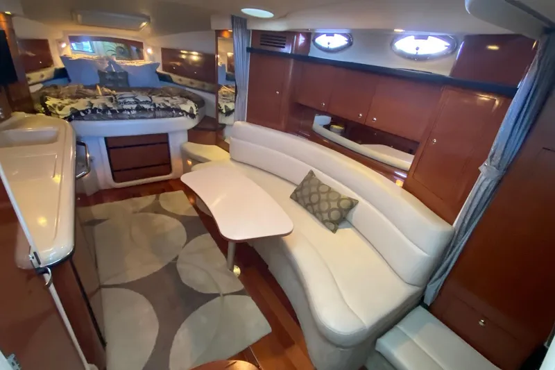 Slide: The Image of Luxurious interior of 2004 Sea Ray 340 Sundancer yacht with elegant seating and cozy bed. - 27