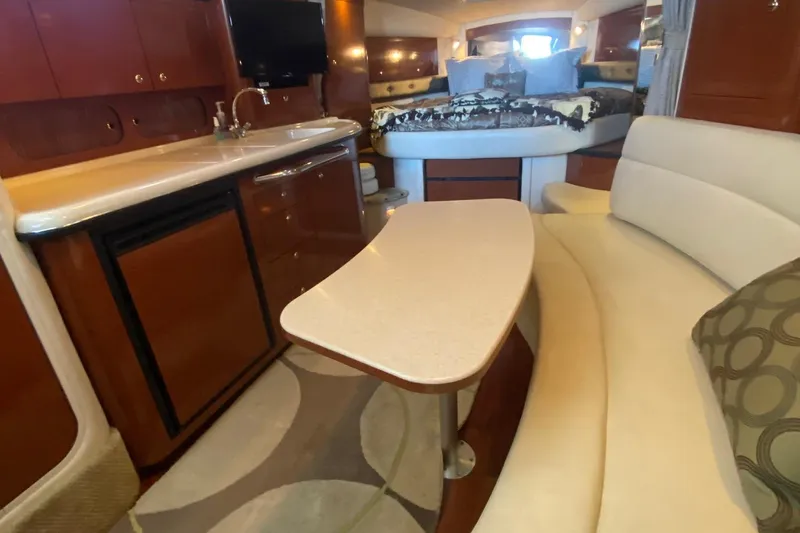 Slide: The Image of Interior of 2004 Sea Ray 340 Sundancer with kitchenette, seating, and bed. - 28