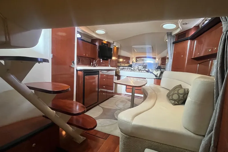 Slide: The Image of Luxurious interior of 2004 Sea Ray 340 Sundancer yacht with elegant seating and kitchenette. - 30