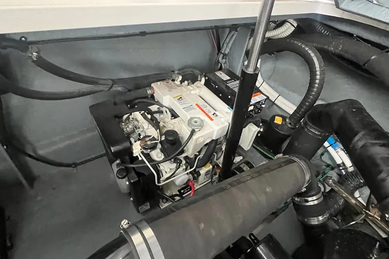 Slide: The Image of Engine compartment of 2004 Sea Ray 340 Sundancer, showcasing mechanical components and wiring. - 32