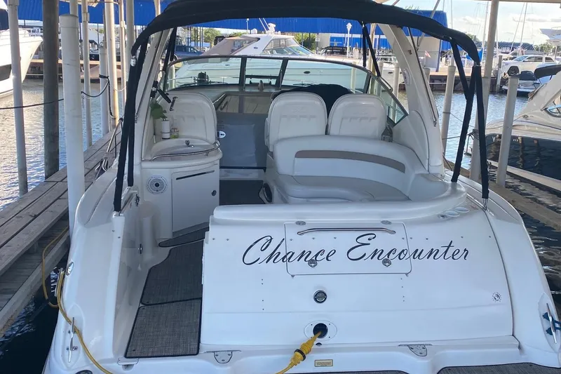 Slide: The Image of 2004 Sea Ray 340 Sundancer boat docked, named "Chance Encounter," with spacious seating area. - 4