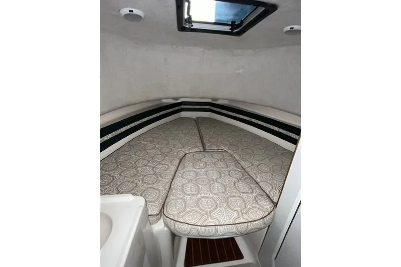 Slide: The Image of 1997 Pursuit 2870 Walkaround cabin interior with patterned cushions and overhead hatch. - 16